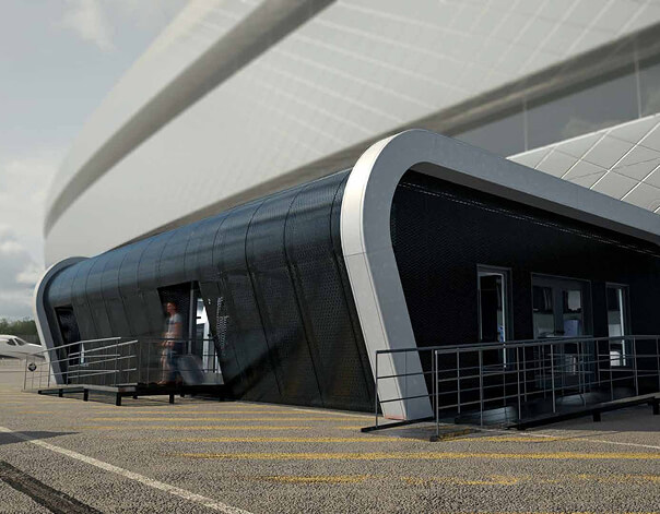 Temporary modular airport building being installed at night on the airside apron, showing off-site constructed terminal extension