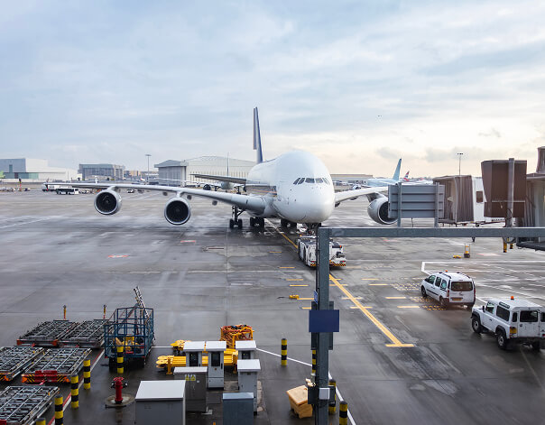 Modular airport terminal building on a live airside apron at dusk, showing TEXO-style low-disruption airport infrastructure